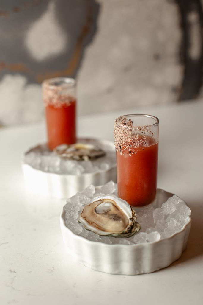 Tipsy Oyster Shooter Two Tipsy Oyster Shooters, shot glasses each with a raw oyster on ice
