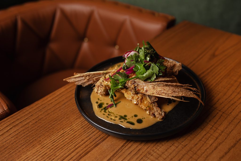Fried Red Snapper Collar Fried Red Snapper Collar with adjika beurre blanc, appetizer on a plate