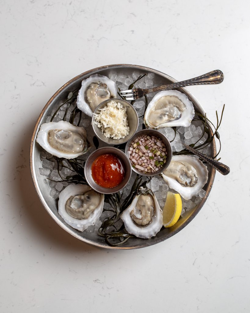 Oysters on the Half Shell Plate of oysters served with garnishes