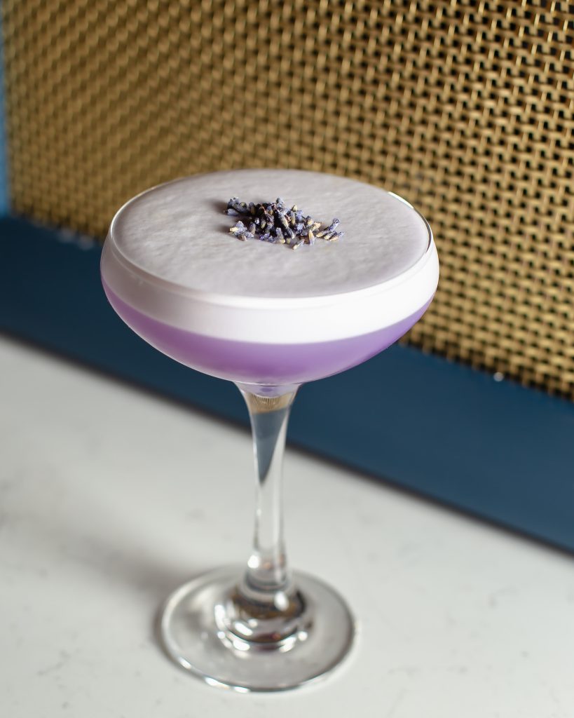 Lavender Sour cocktail resting on bar