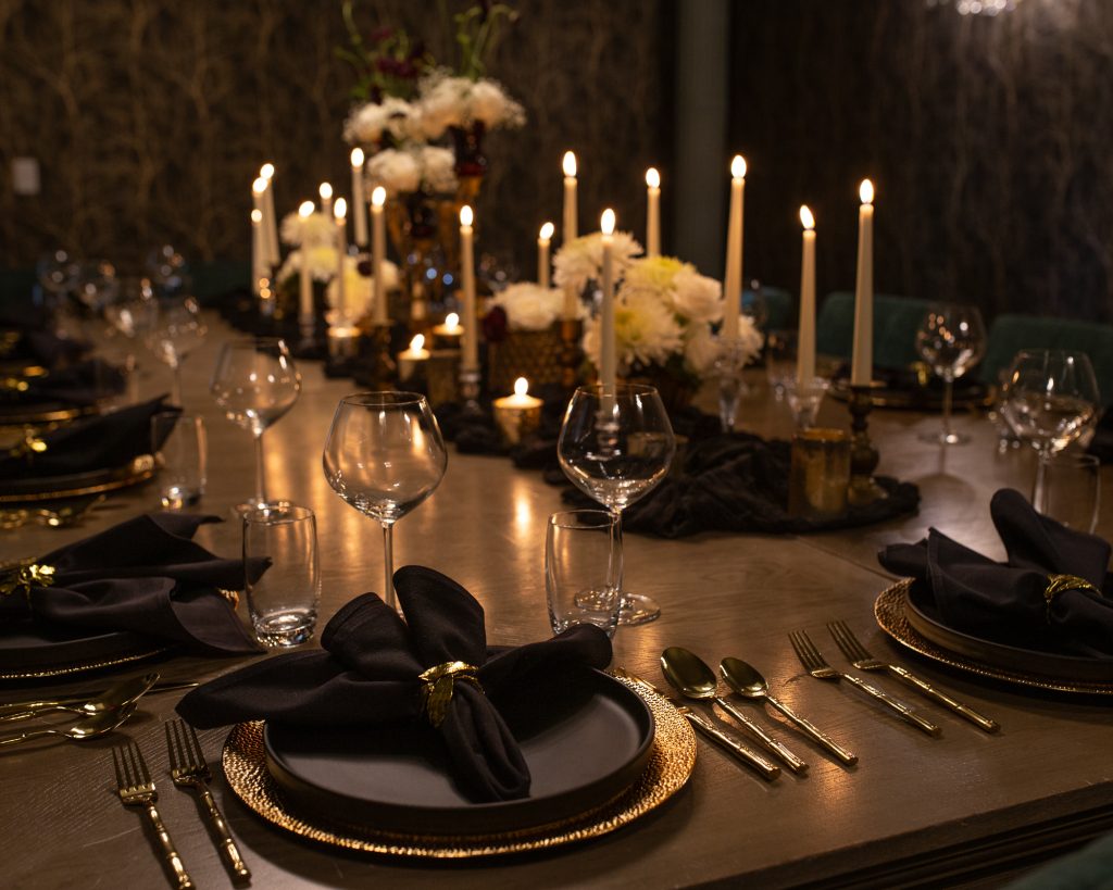 Private dining room with one large decorated table, and place settings for guests