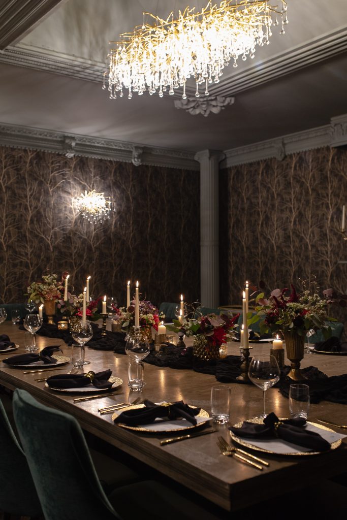 Private dining room with one large decorated table, and place settings for guests