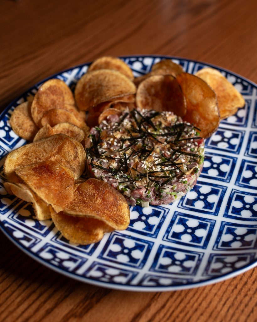 Wagyu Steak Tartare on a plate, with potato chips